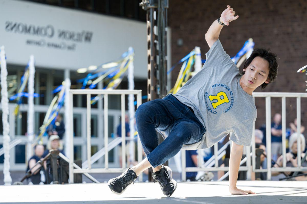 At the University of Rochester, a man executes a handstand demonstrating impressive athleticism.